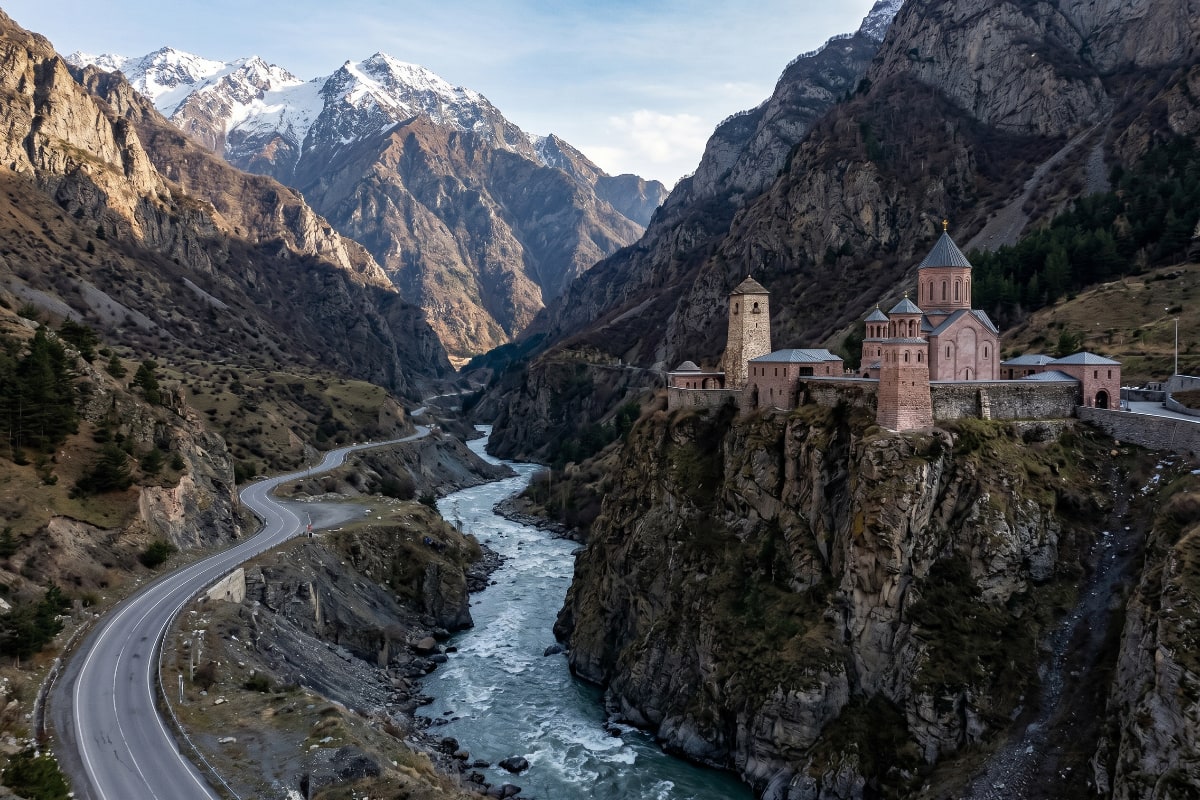 Dariali Gorge with steep limestone walls and the rushing Terek River below