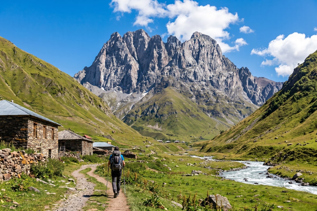 The broad green meadows and rocky peaks of Juta Valley